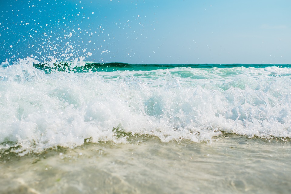 A Picture of Waves At The Beach By A Hotel