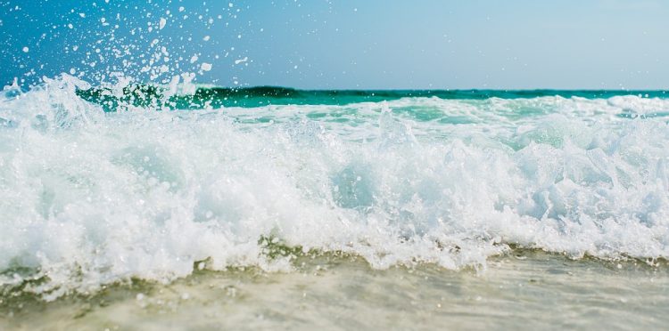 A Picture of Waves At The Beach By A Hotel